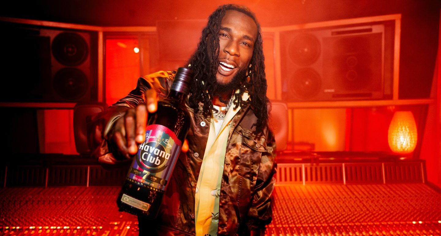Burna Boy at the studio with the limited edition bottle in hand